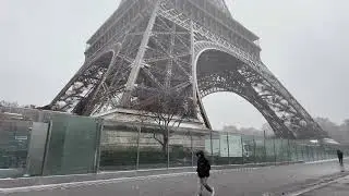Hard Snow and tempest under the pillars of the Eiffel Tower, Paris