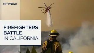 LA firefighters race to contain flames amid wind threat