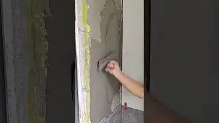 Applying fresh cement plaster smoothly on interior wall surface