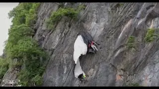 Watch the dramatic rescue of a BASE jumper caught dangling on a cliffside in Thailand