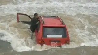 Man and his car washed into swollen river in China