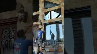 Fancy pole work cleaning a triangle window 12 ft up
