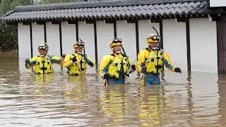 Typhoon Hagibis: Japanese rescue workers wade through muddy waters searching for survivors
