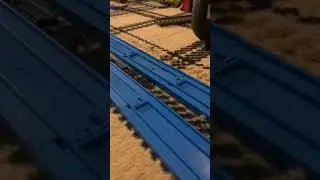 Streamlined steam locomotive pulling a goods train