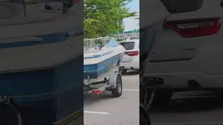 Dodge Durango with inboard ski boat on street