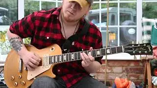 Dave Strange warms up on his Les Paul Guitar