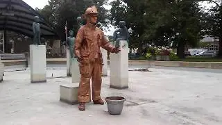 Copper Fireman Living Statue in Bronson Park Reflecting Pool - downtown Kalamazoo