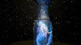Handmade, mysterious mermaid on a glass bottle with volumetric details made of salt dough.