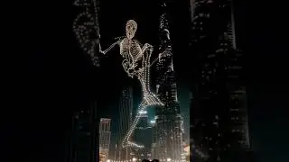 Skeleton climbs Burj Kalifa. Halloween in Dubai UAE. Drones holograms.