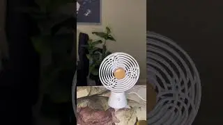 Kinetic desk fan, meditation accessories, mindfulness practice, serene environment, ambiance