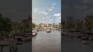 Boats floating near the National Opera music and theatre venue timelapse. Amsterdam, The Netherlands
