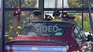 At least two injured after car plows into Starbucks storefront