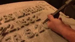 Carving a raised letter inscription into granite for a headstone