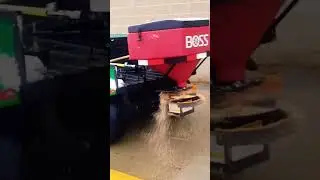 John Deere Gator spreading ice melt with a BOSS tailgate spreader
