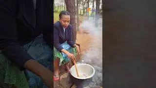 African woman preparing food in a traditional way