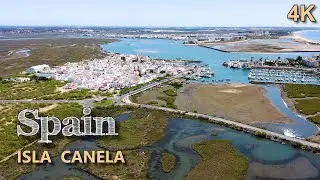 Aerial view of Isla del Moral and Puerto Deportivo Isla Canela, Huelva. UHD 4K.
