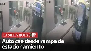 Auto se desploma por falla en rampa de estacionamiento