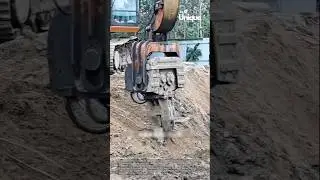 Removing a steel plate with an excavator: people removing a steel plate with an excavator