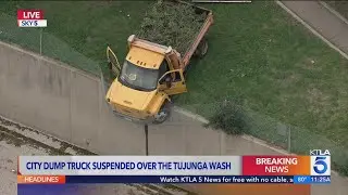 City dump truck suspended over Tujunga Wash in L.A. County