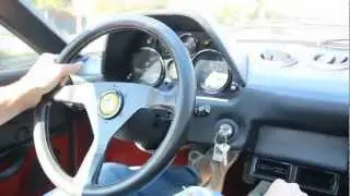 A Ferrari 308 1978 riding in the streets of Modena