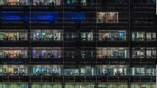 Modern office building with big windows at night timelapse, in windows light shines
