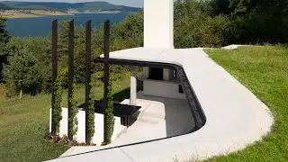 One half of the house built into the hillside and the other rising above ground in an insulated