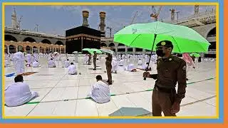 knowledge || Members || of the Saudi security forces holding umbrellas stand guard |