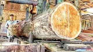 Sawing solid teak wood into strong beams for building beautiful houses