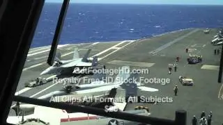 US Navy F-18 Fighter Jet is Towed Across Aircraft Carrier Flight Deck by GotFootageHD.com