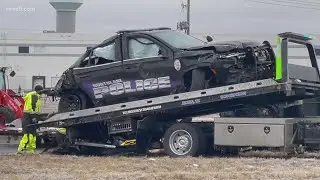 Semi-truck crashes into officer's vehicle, landing on top of police unit