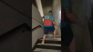 World's strongest mover walks down flight upstairs with couch backwards