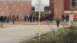 Parents waiting outside Akins High School during a lockdown at the school