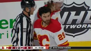Dillon Dube has his helmet shoved off by Nino Niederreiter