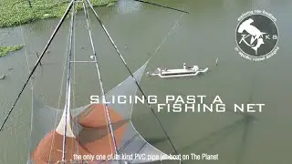 Slicing past a fishing net: A fantastic PVC pipe jet-boat on our lush green scenic river