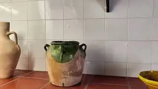 Beautifully Crafted Rustic Ceramic Pots Arranged on a Tile Countertop in a Cozy Kitchen