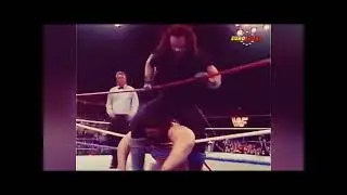Undertaker - Middle Rope-Positioned Leg Guillotine Choke