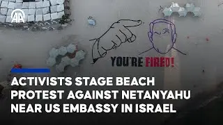 A group of activists gathered on beach opposite US Embassy in Israel to protest against PM Netanyahu