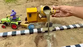 Diy mini tractor repairing big pit on road using construction mixer machine science project
