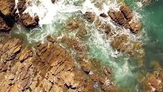 Rocky Coastline Drama: Sea Waves Break on Rugged Shores 🌊🪨✨