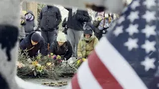 Makeshift memorial set up for ICU nurse killed by US federal agents | AFP