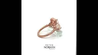 Fancy pink cushion diamond engorging with shield diamond side stones