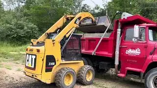 Grading a driveway with a CAT 236b skidsteer and the piggy bank!