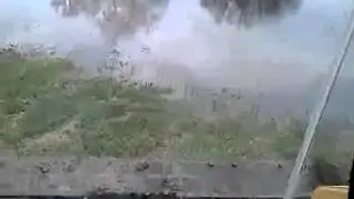 Cat 247B driving through the pond.
