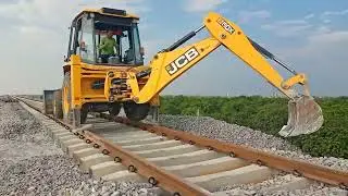 Ballast filling in railway track with jcb 3dx machine