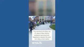 Striking Libbey Glass workers march to Glass City Center in downtown Toledo