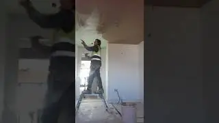 Applying first coat to new plasterboard ceiling with British Gypsum Multifinish