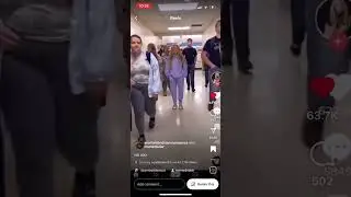 Military kid walking around girl in school hallway.