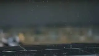 Drops of Rain hitting the ground in slow motion