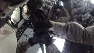 Fast roping from a CH-53 Sea Stallion onto ship flight deck at sea