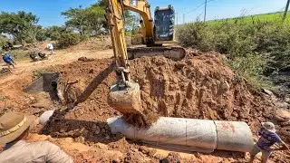 Digging soil to bury a drainage canal with a CAT312 excavator 